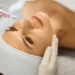 Woman receiving microneedling skin treatment